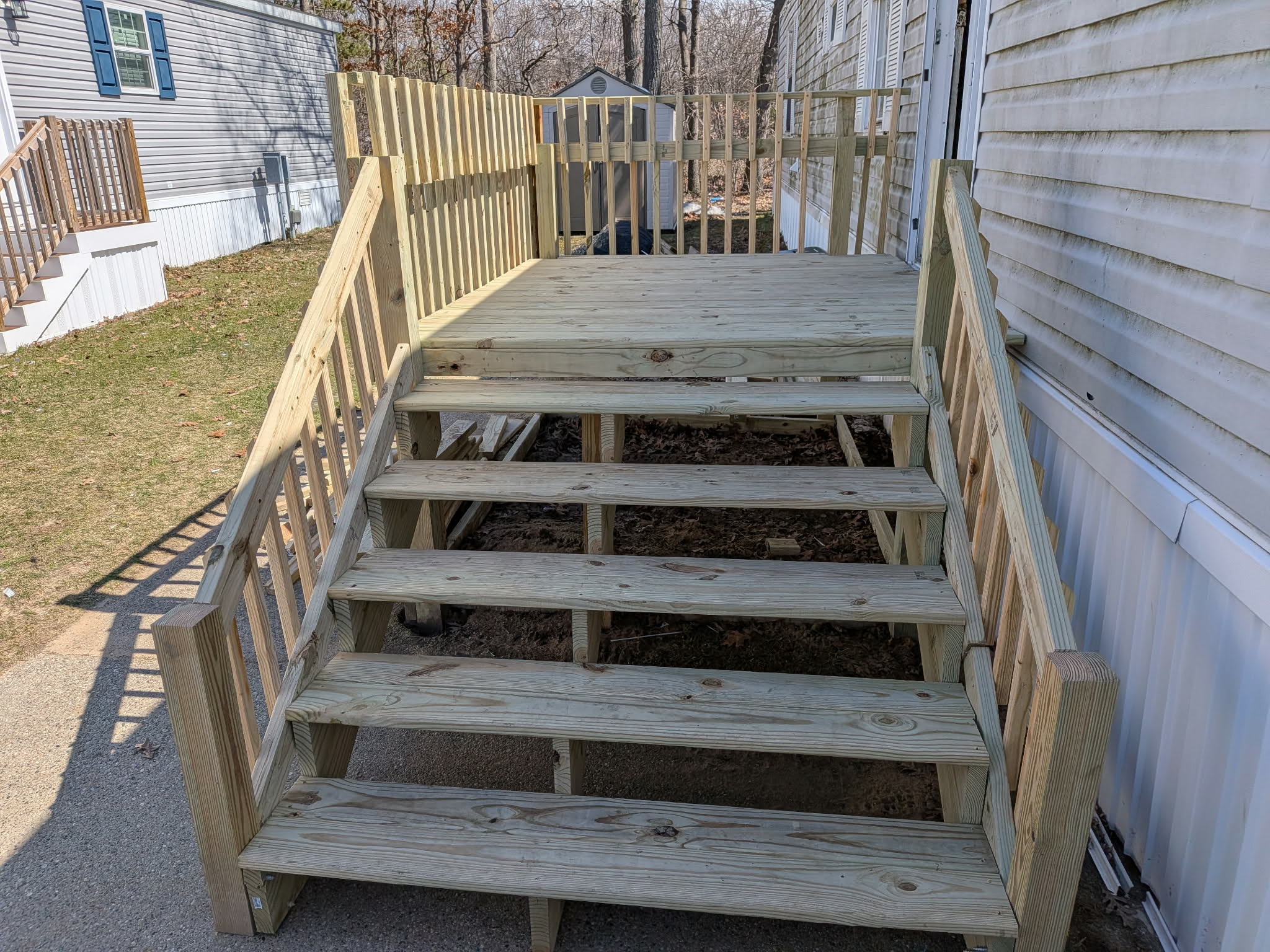 Completed deck and stair build with railing